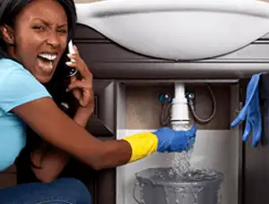 Emergency plumbing repair for a leaking sink drain under a bathroom vanity in Peoria, IL