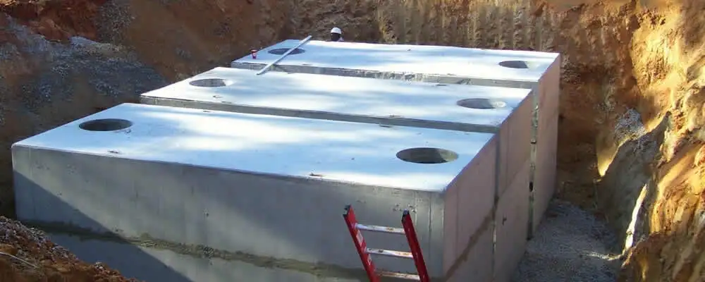 Septic tank installation site with a newly placed concrete tank in Peoria, IL